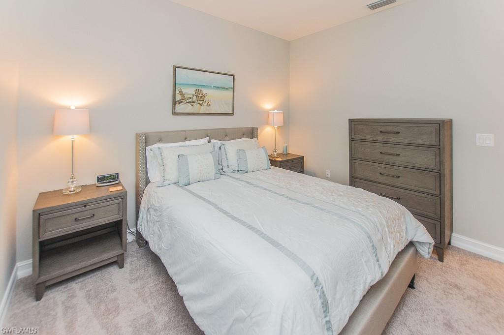 14670 Catamaran Place Naples, FL 34114 - Photo 15 of 24 a bedroom with a bed and a dresser