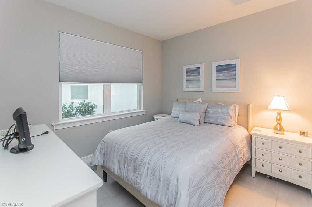 14670 Catamaran Place Naples, FL 34114 - Photo 17 of 24 a bedroom with a bed and a window