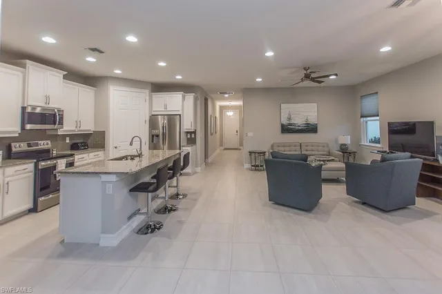a large kitchen with stainless steel appliances lots of counter top space