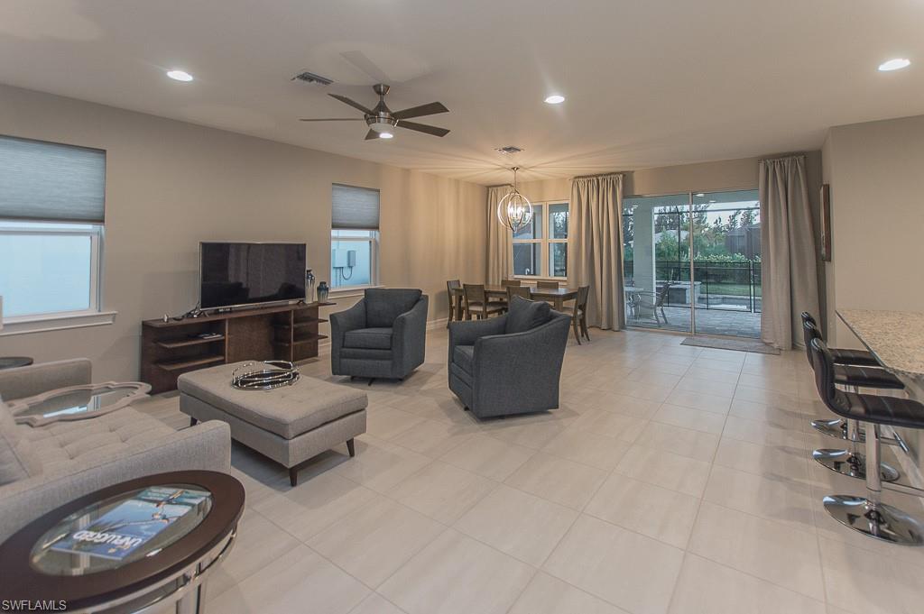 14670 Catamaran Place Naples, FL 34114 - Photo 5 of 24 a living room with furniture a flat screen tv and a window