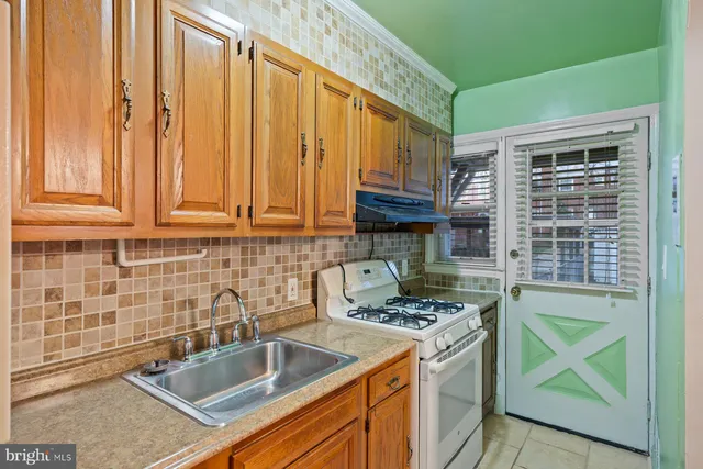 a kitchen with stainless steel appliances granite countertop a sink stove and cabinets
