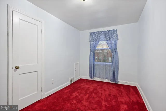 a view of a room with wooden floor and windows