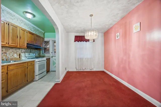 a kitchen that has a lot of cabinets and wooden floor