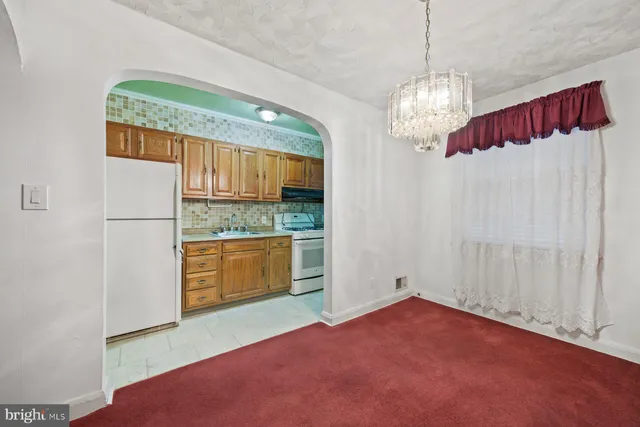a open kitchen with window and stainless steel appliances