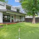 a view of a house with a yard and sitting area