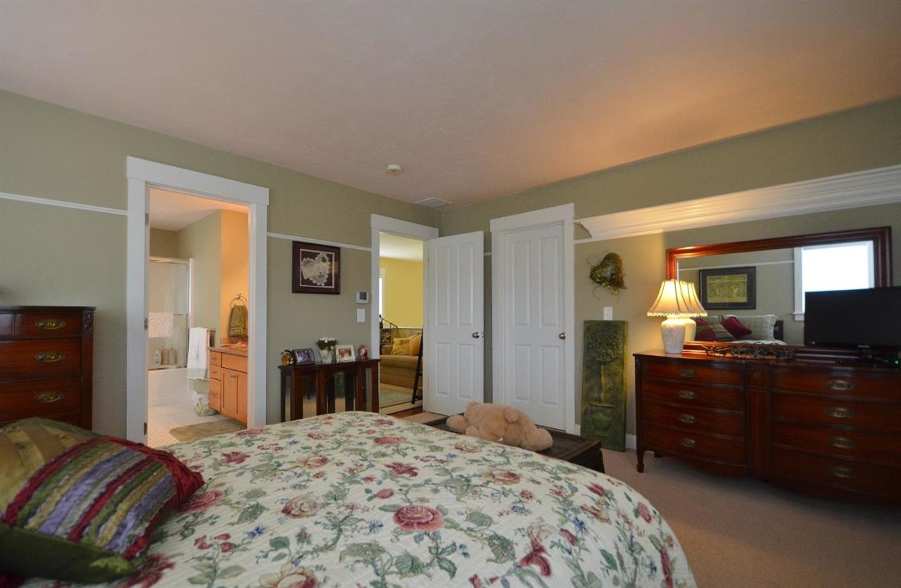13 Aspen Road Buzzards Bay, MA 02532 - Photo 22 of 29 a bedroom with a bed and wooden floor
