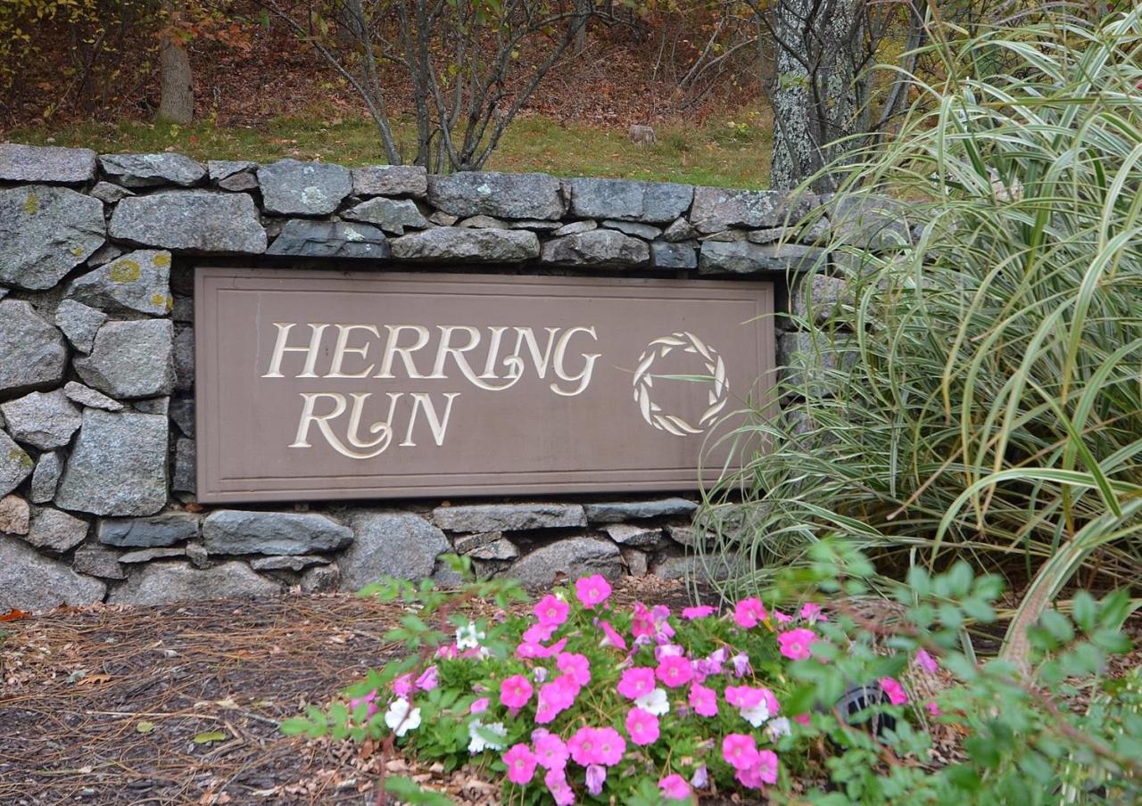 13 Aspen Road Buzzards Bay, MA 02532 - Photo 29 of 29 a sign that is sitting on a wooden wall