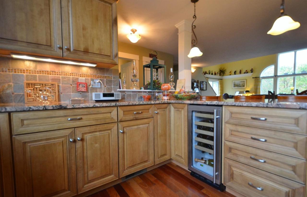 13 Aspen Road Buzzards Bay, MA 02532 - Photo 6 of 29 a kitchen with kitchen island granite countertop a sink cabinets and wooden floor