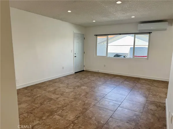 an empty room with large windows