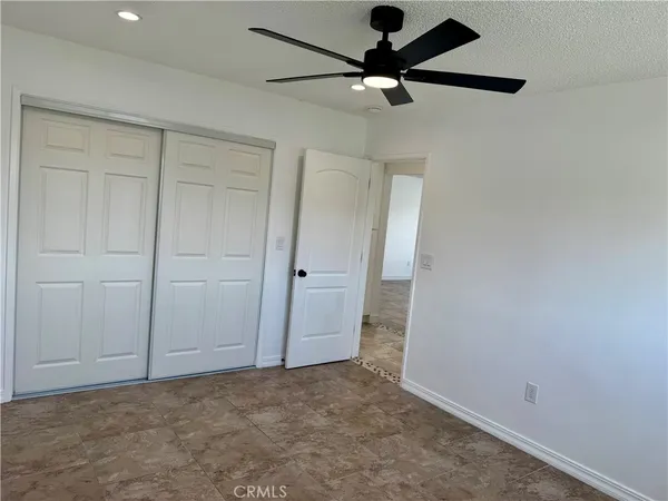 an empty room with a ceiling fan