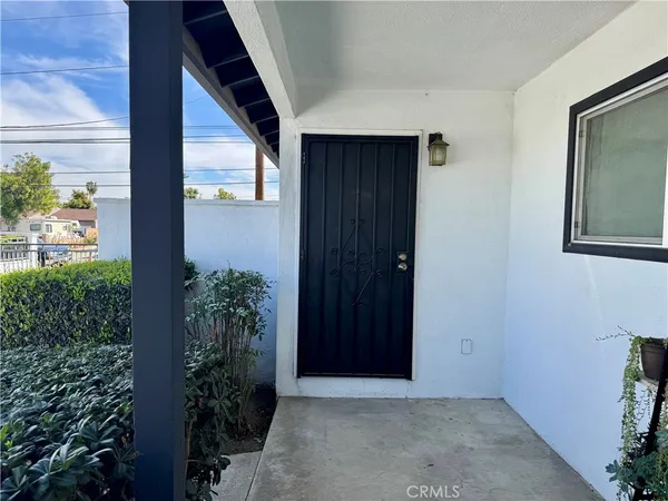 an empty room with potted plants