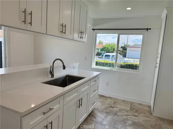 a kitchen with a sink and large window