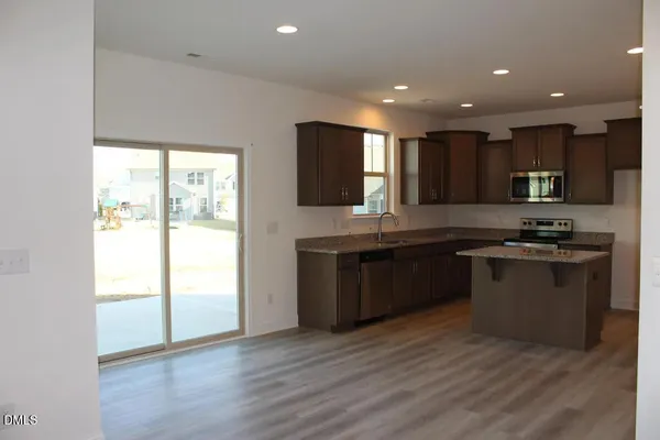 a stove top oven sitting inside of a kitchen