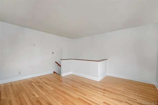 a room with a bed and wooden floor