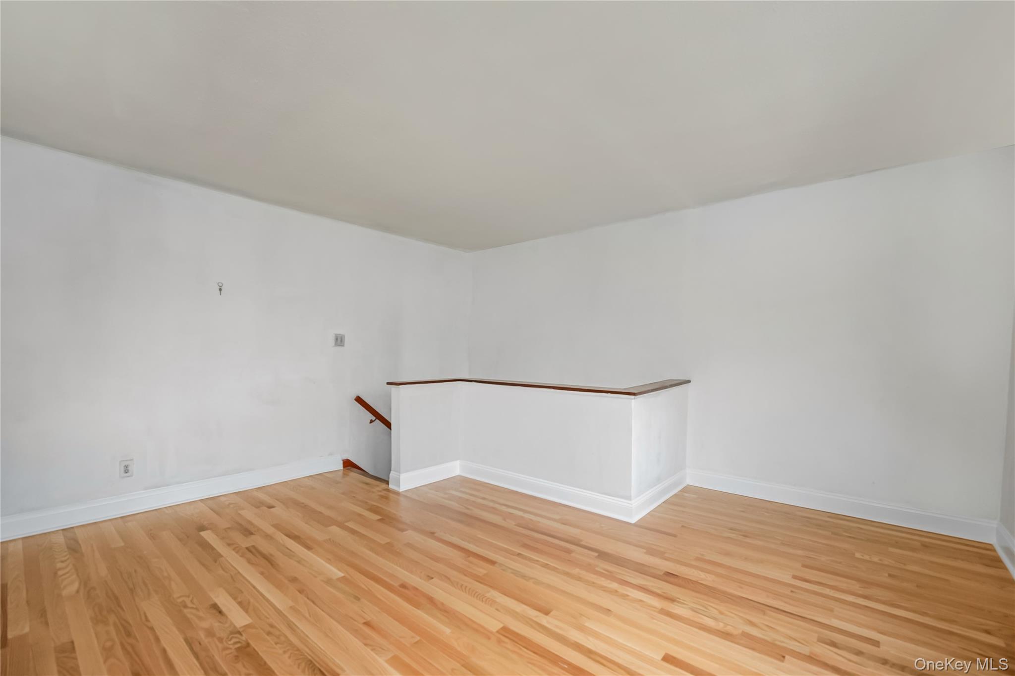 6703 136th Street, Unit B Queens, NY 11367 - Photo 6 of 14 a room with a bed and wooden floor