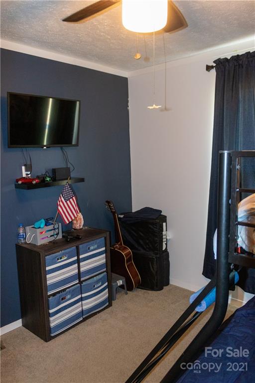11 Fernwood Road Clyde, NC 28721 - Photo 16 of 26 a bedroom with a bed and flat screen tv