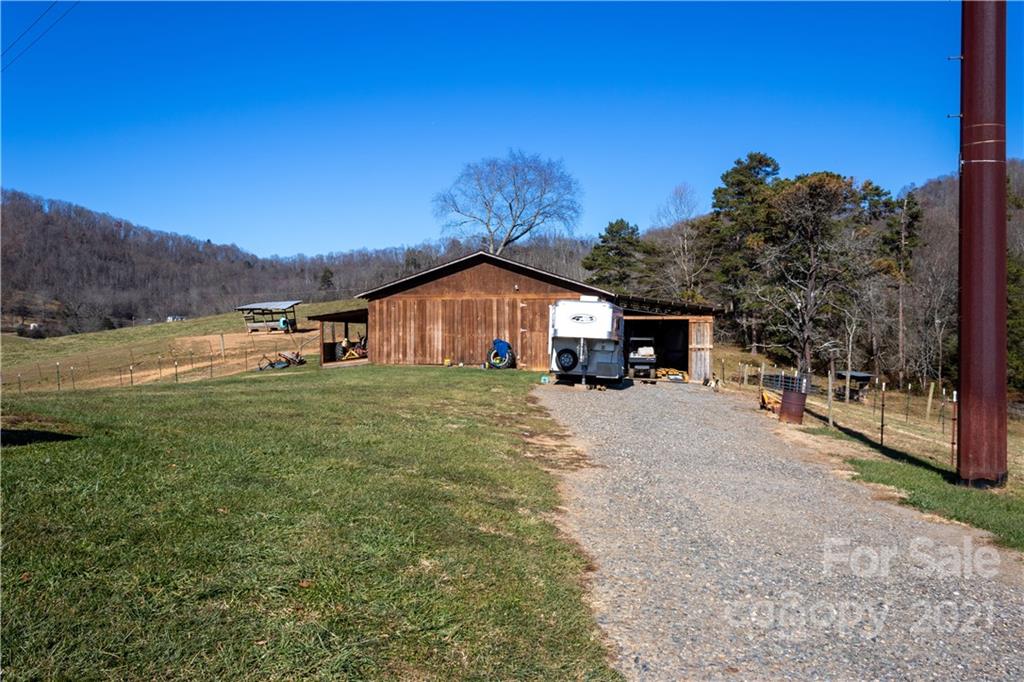 11 Fernwood Road Clyde, NC 28721 - Photo 19 of 26 a front view of a house with a yard and garage