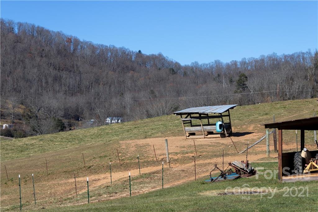 11 Fernwood Road Clyde, NC 28721 - Photo 21 of 26 a view of a town with barn house in the background