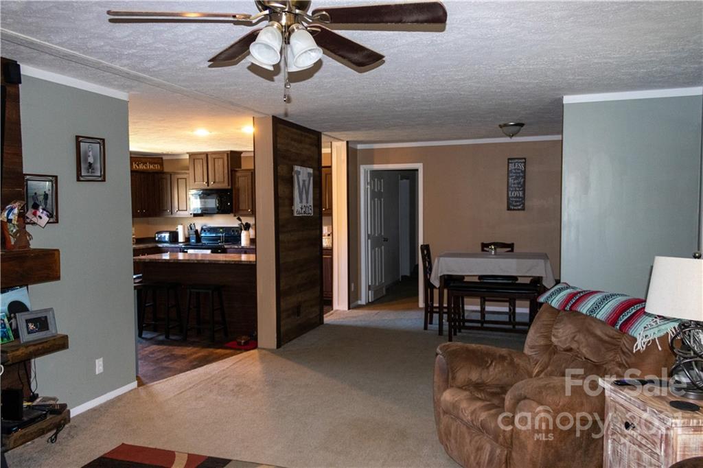 11 Fernwood Road Clyde, NC 28721 - Photo 6 of 26 a open kitchen with stainless steel appliances granite countertop a stove refrigerator and dining table with wooden floor