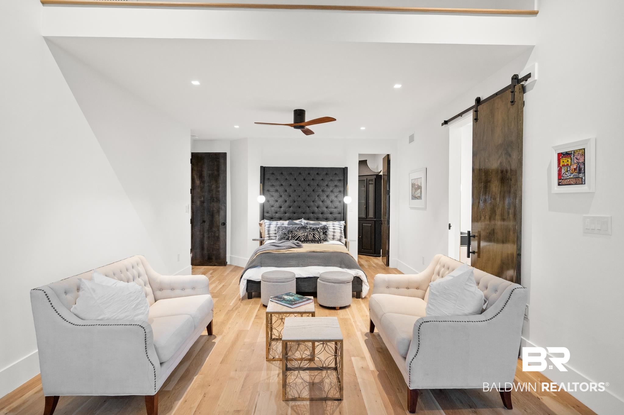 33349 River Road Orange Beach, AL 36561 - Photo 19 of 61 Bright living area featuring wood-finish flooring, recessed lighting, and a dark wood barn door