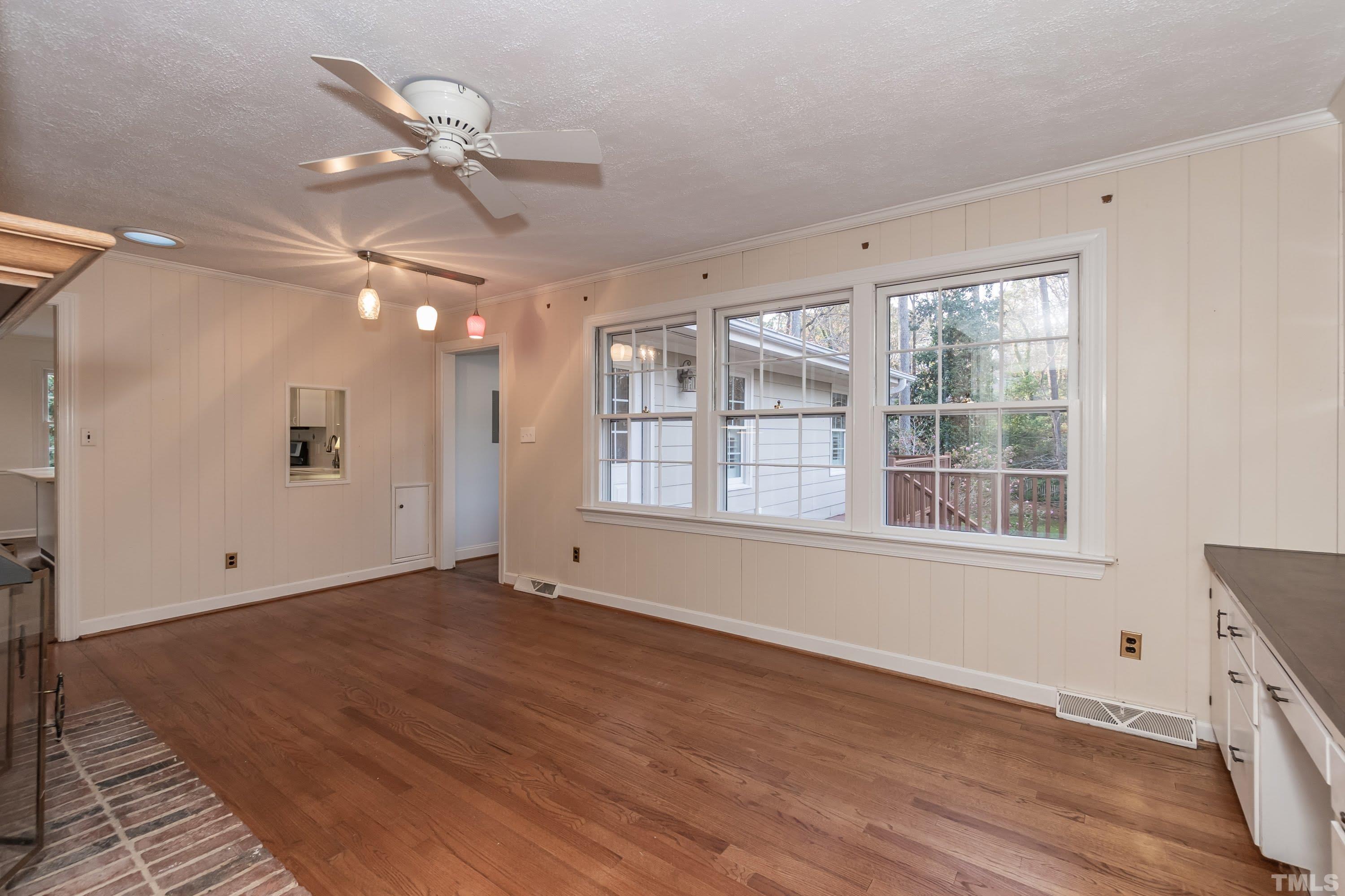 1104 Deboy Street Raleigh, NC 27606 - Photo 12 of 38 a view of an empty room with a window and wooden floor