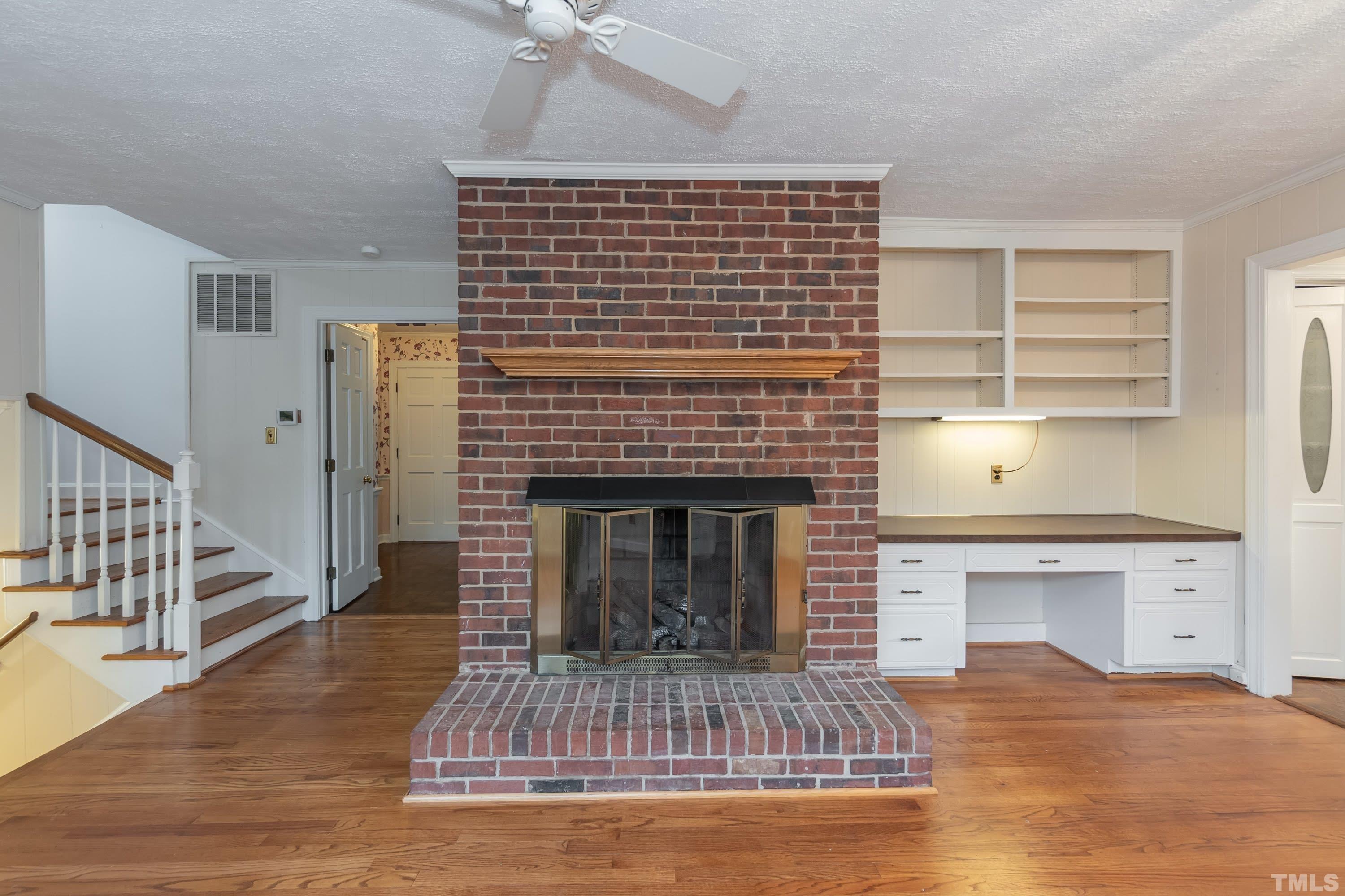 1104 Deboy Street Raleigh, NC 27606 - Photo 16 of 38 a living room with a fireplace and wooden floor
