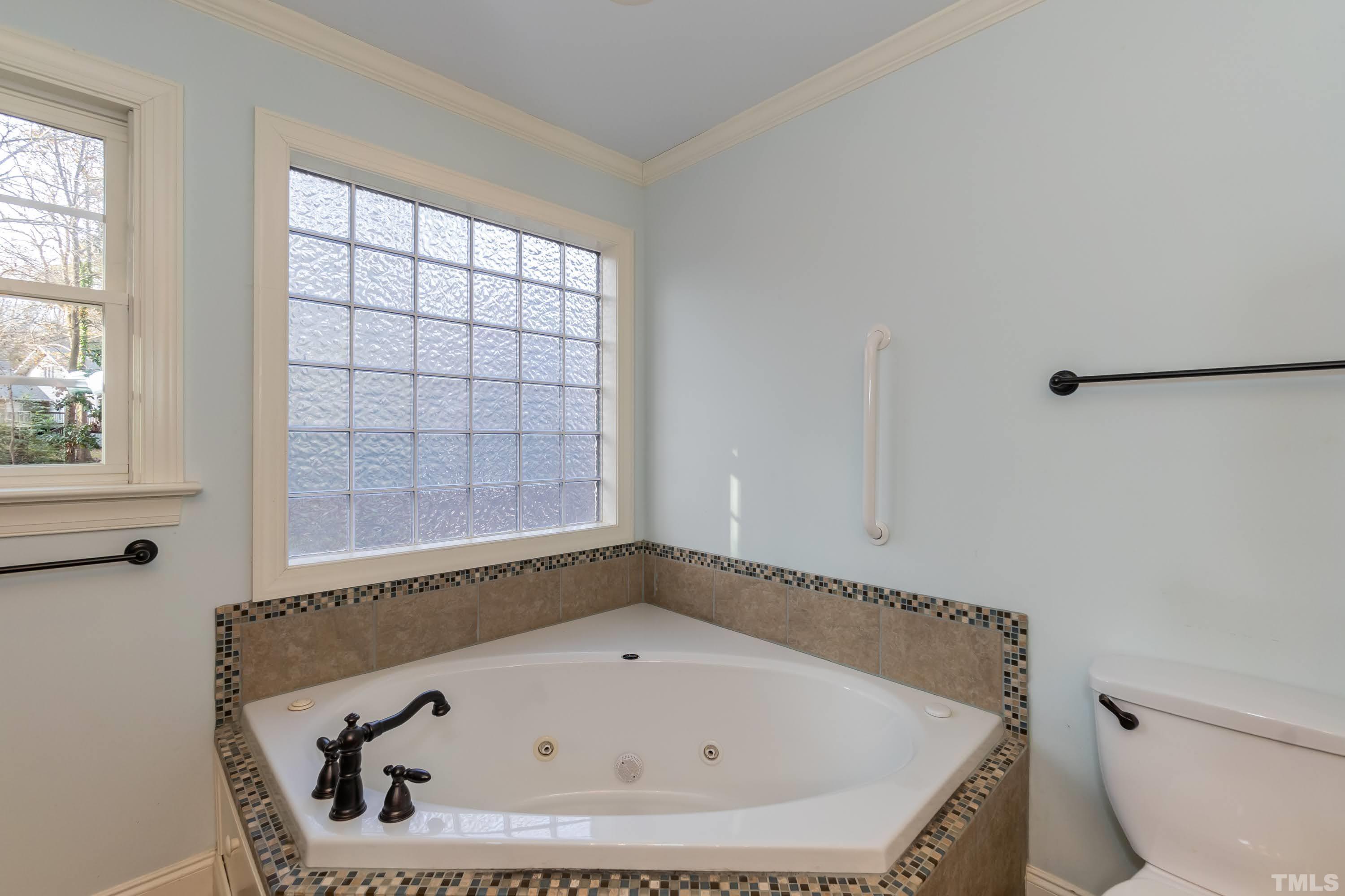 1104 Deboy Street Raleigh, NC 27606 - Photo 19 of 38 a bathroom with a tub and window