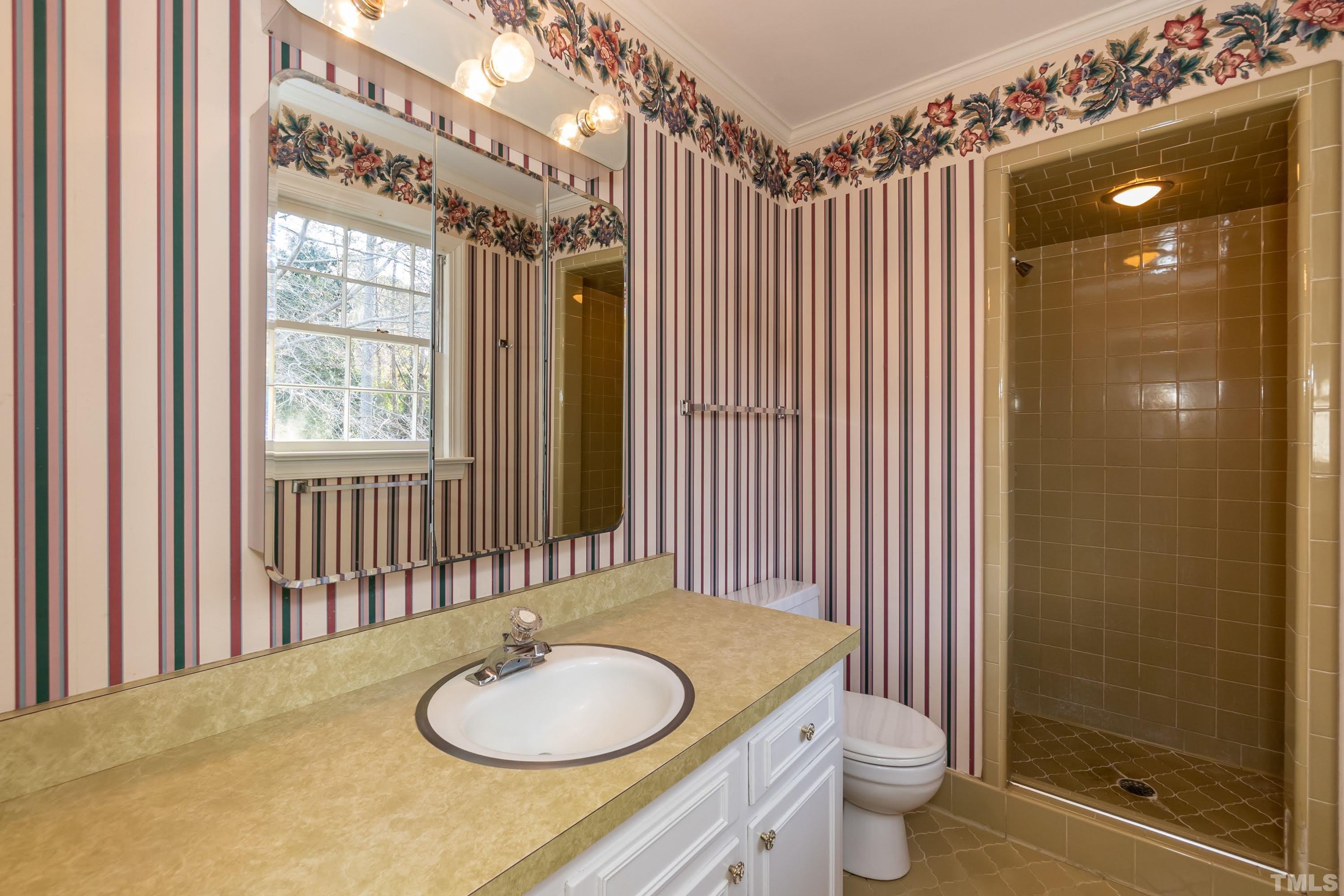 1104 Deboy Street Raleigh, NC 27606 - Photo 35 of 38 a bathroom with a granite countertop sink and a mirror