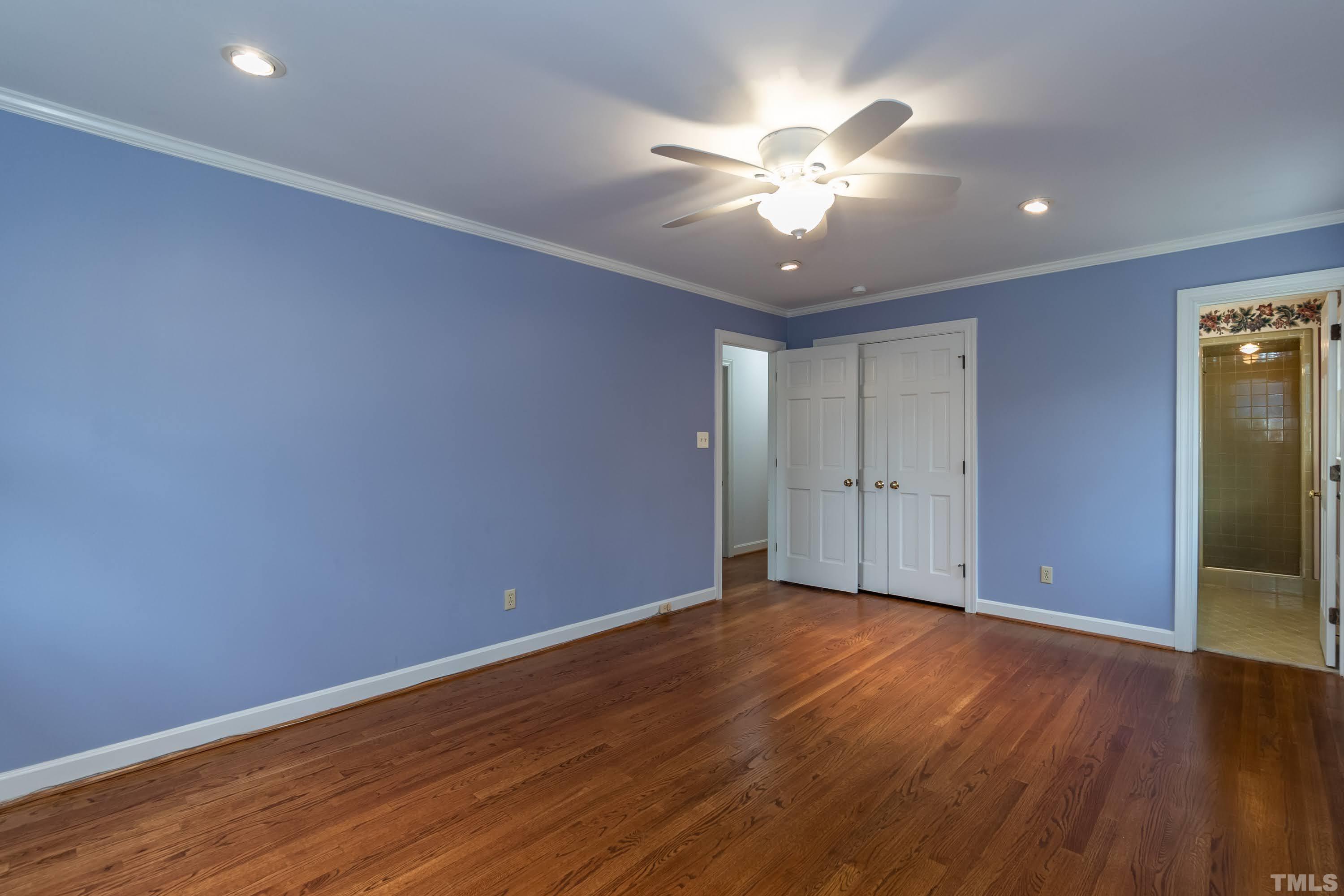 1104 Deboy Street Raleigh, NC 27606 - Photo 36 of 38 a view of an empty room with wooden floor and a ceiling fan