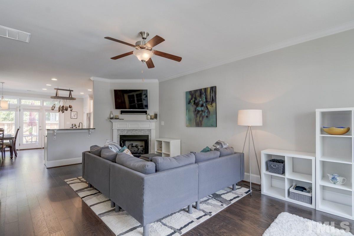 527 Ledbetter Court Raleigh, NC 27608 - Photo 4 of 13 a living room with furniture a ceiling fan and a flat screen tv