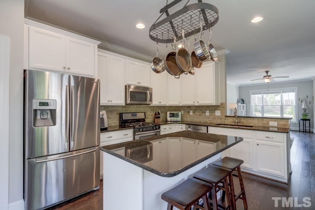 527 Ledbetter Court Raleigh, NC 27608 - Photo 6 of 13 a kitchen with a center island appliances and cabinets