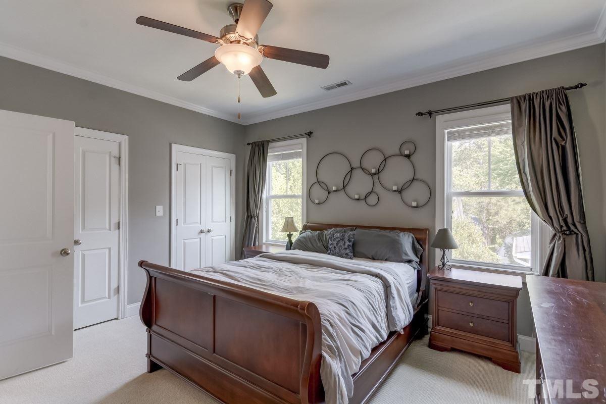 527 Ledbetter Court Raleigh, NC 27608 - Photo 9 of 13 a bed sitting in a bedroom next to a window