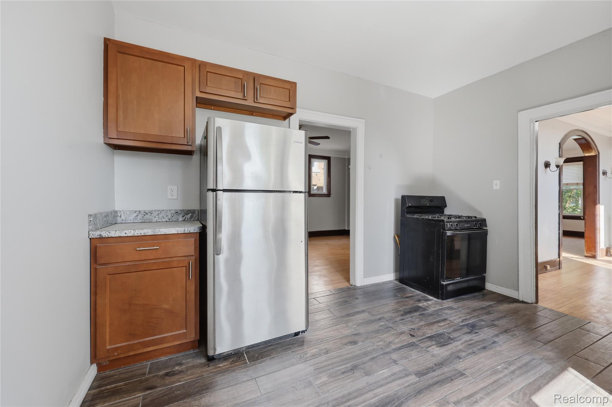1945 Atkinson Street Detroit, MI 48206 - Photo 19 of 49 Kitchen featuring wood-finish flooring, light gray wall paint, and overhead cabinetry