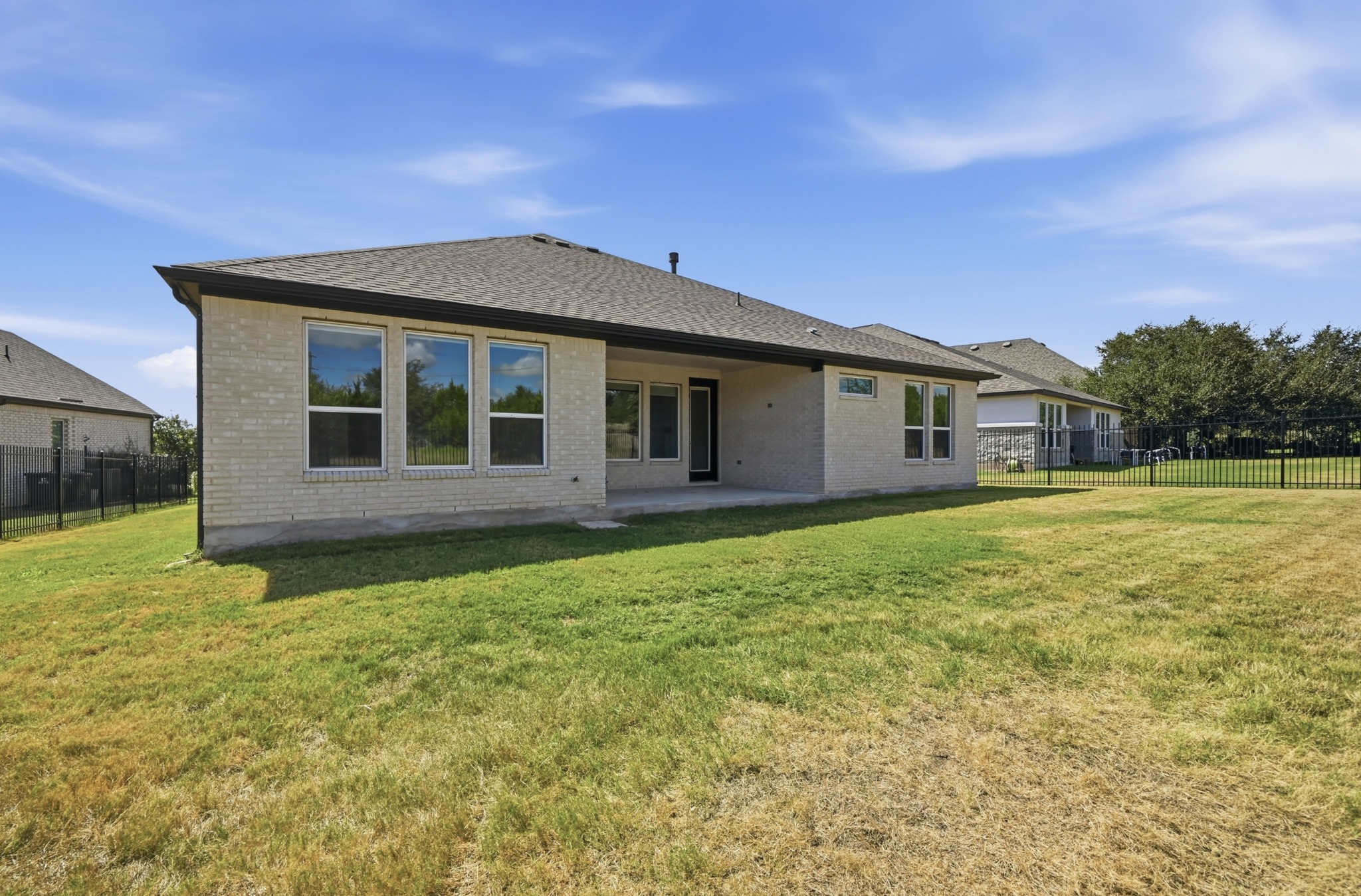 433 Running Bird Road Austin, TX 78737 - Photo 39 of 40 A spacious, naturally illuminated rear yard features a covered patio and sturdy perimeter fencing.