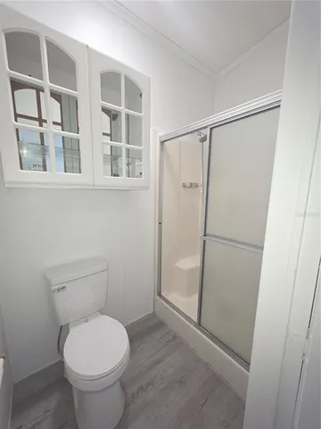 a bathroom with a toilet and a shower