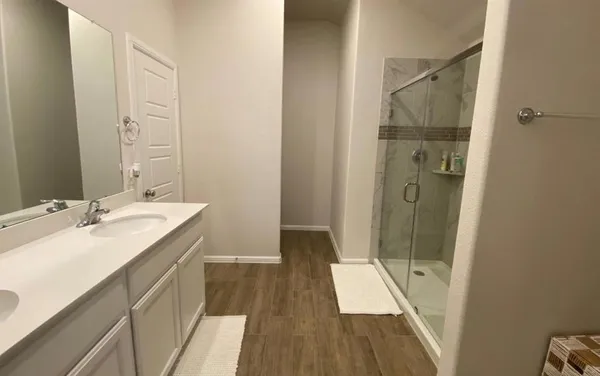 a bathroom with a sink a toilet a shower and a mirror