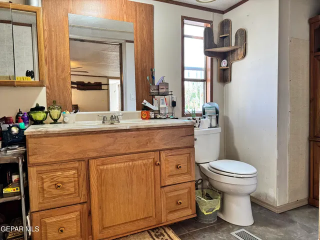 a bathroom with a sink toilet and mirror