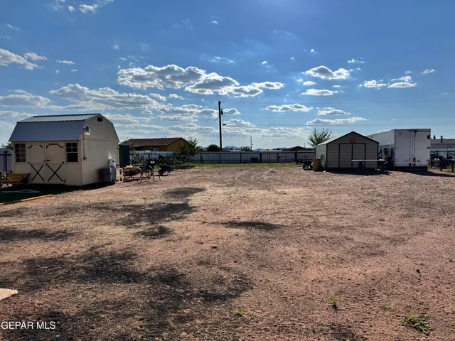 a large kitchen with kitchen island a sink stainless steel appliances and a chandelier