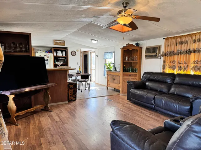 a living room with furniture flat screen tv and wooden floor