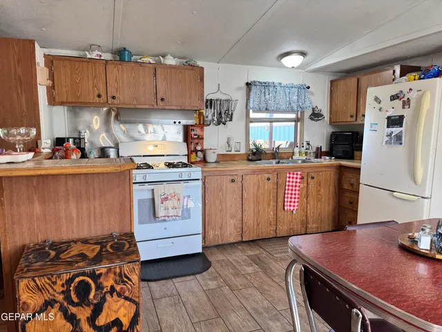 a kitchen with stainless steel appliances granite countertop a stove refrigerator sink and cabinets