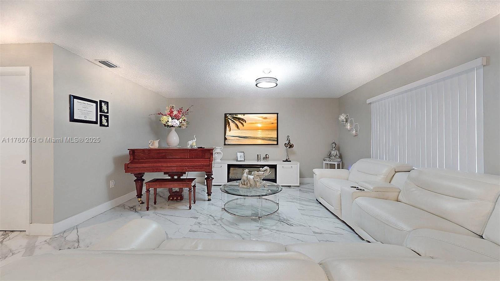 13539 Southwest 62nd Street, Unit 1 Miami, FL 33183 - Photo 15 of 38 a living room with furniture and a piano
