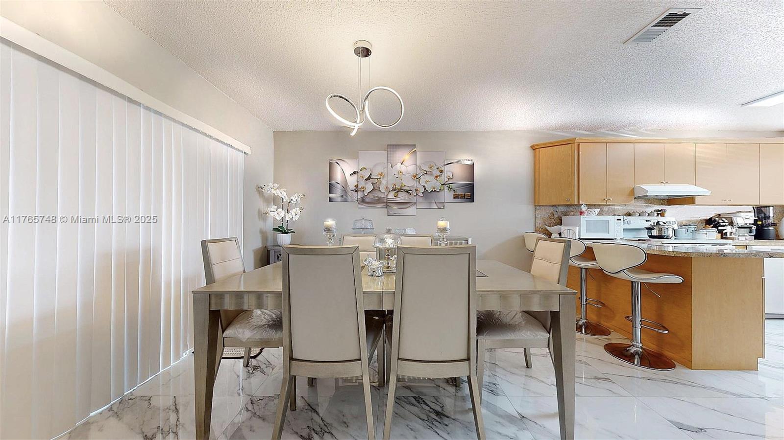 13539 Southwest 62nd Street, Unit 1 Miami, FL 33183 - Photo 17 of 38 a kitchen with kitchen island granite countertop furniture and a refrigerator