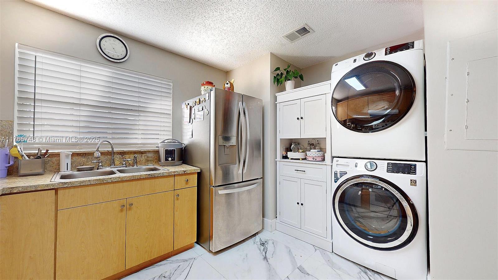 13539 Southwest 62nd Street, Unit 1 Miami, FL 33183 - Photo 23 of 38 a kitchen with a washer and dryer