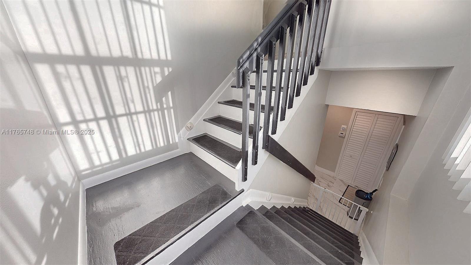 13539 Southwest 62nd Street, Unit 1 Miami, FL 33183 - Photo 24 of 38 a view of staircase with white walls and a window
