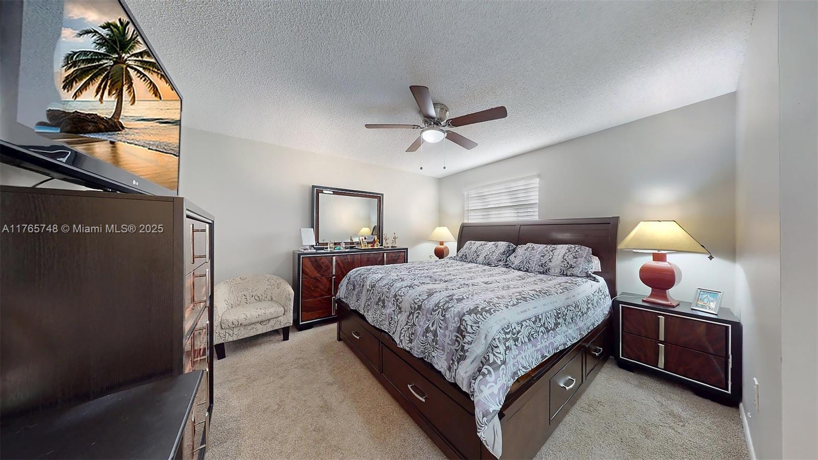 13539 Southwest 62nd Street, Unit 1 Miami, FL 33183 - Photo 26 of 38 a bedroom with a bed and a chandelier