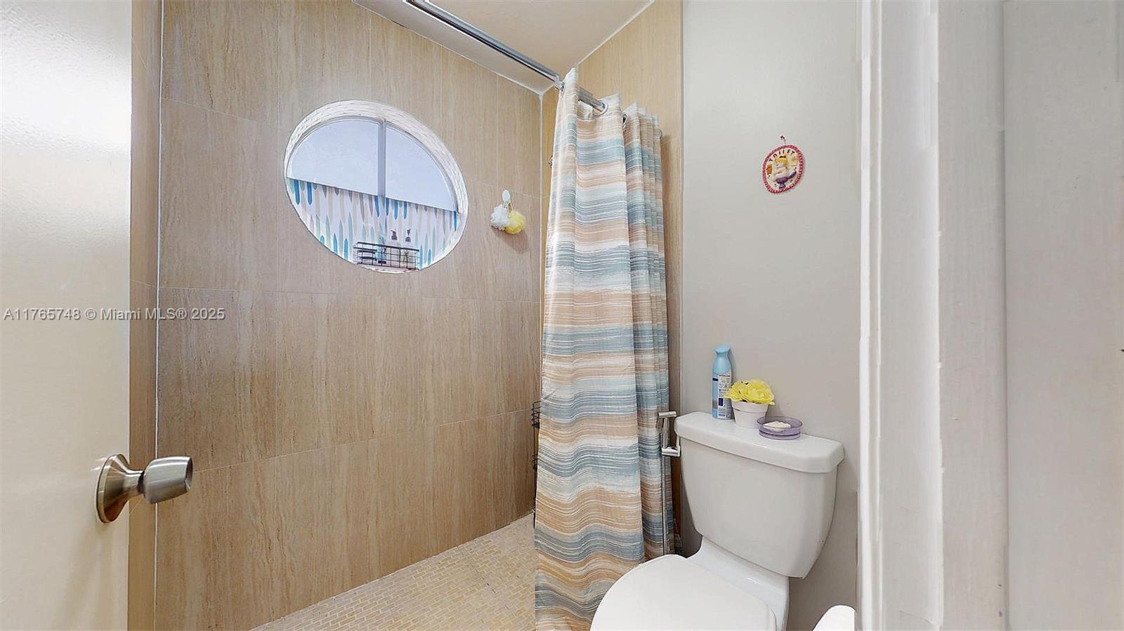 13539 Southwest 62nd Street, Unit 1 Miami, FL 33183 - Photo 27 of 38 a white toilet sitting next to a bathroom sink and tub