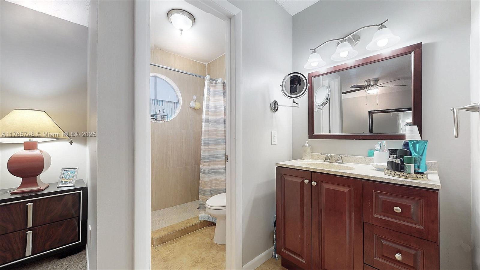13539 Southwest 62nd Street, Unit 1 Miami, FL 33183 - Photo 28 of 38 a bathroom with a double vanity sink and a mirror