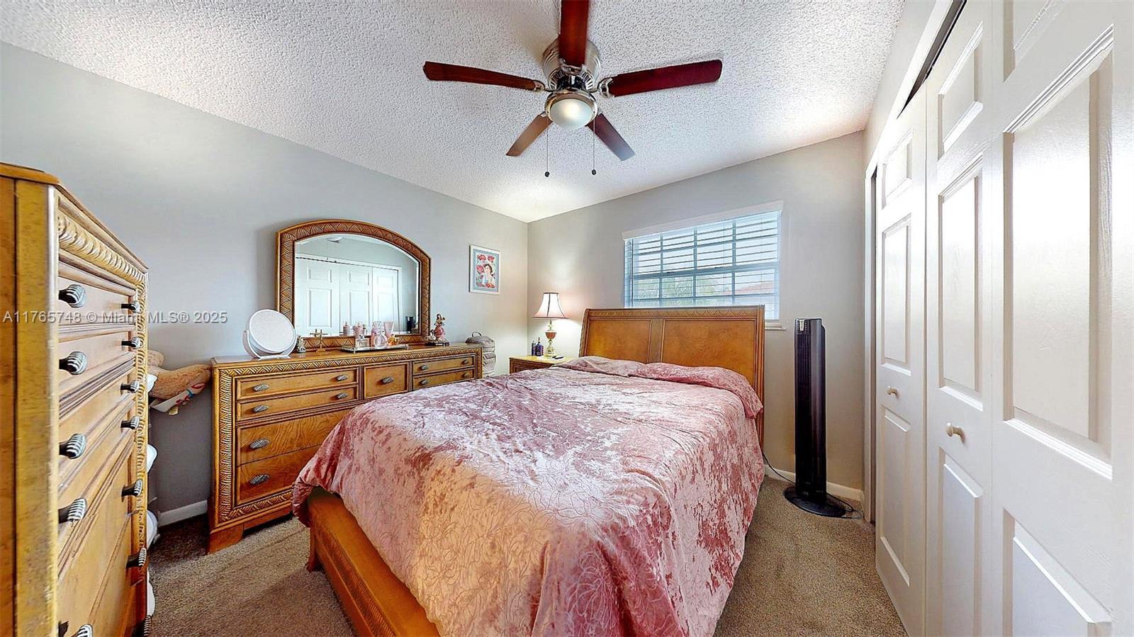 13539 Southwest 62nd Street, Unit 1 Miami, FL 33183 - Photo 29 of 38 a bed room with a bed and a chandelier