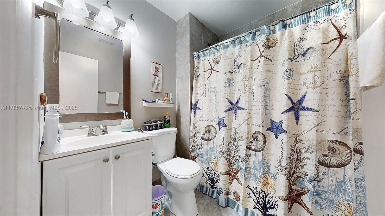 13539 Southwest 62nd Street, Unit 1 Miami, FL 33183 - Photo 30 of 38 a bathroom with a granite countertop toilet sink and mirror