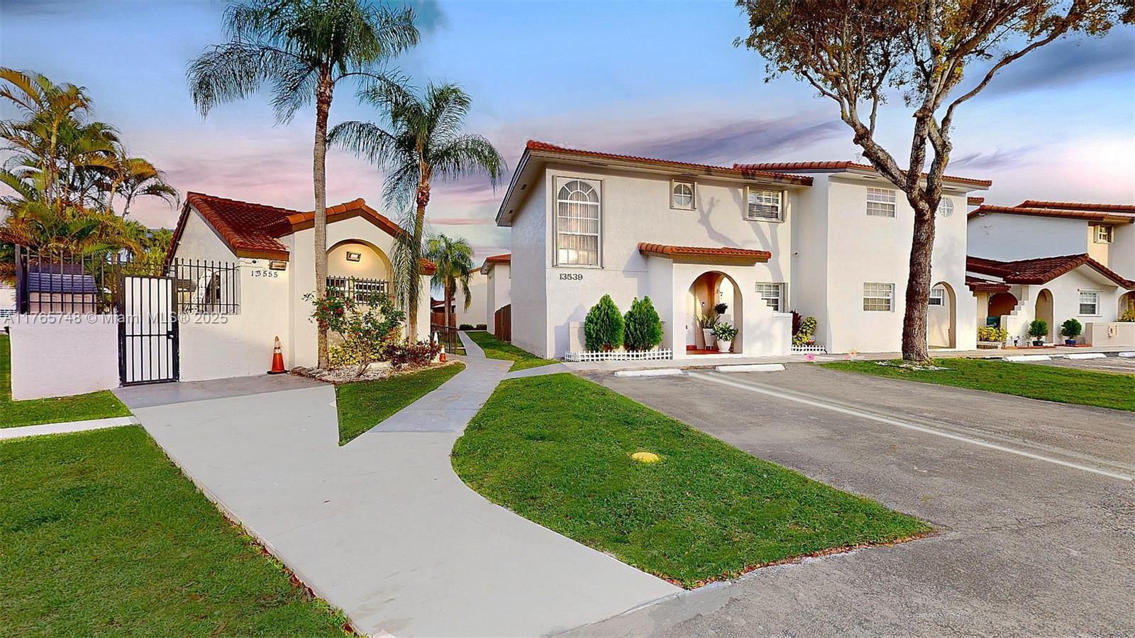 13539 Southwest 62nd Street, Unit 1 Miami, FL 33183 - Photo 3 of 38 a front view of a house with a yard and garage